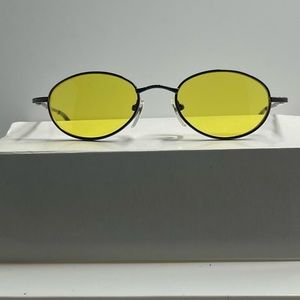 Classy retro dark gray metal frame with yellow lens.